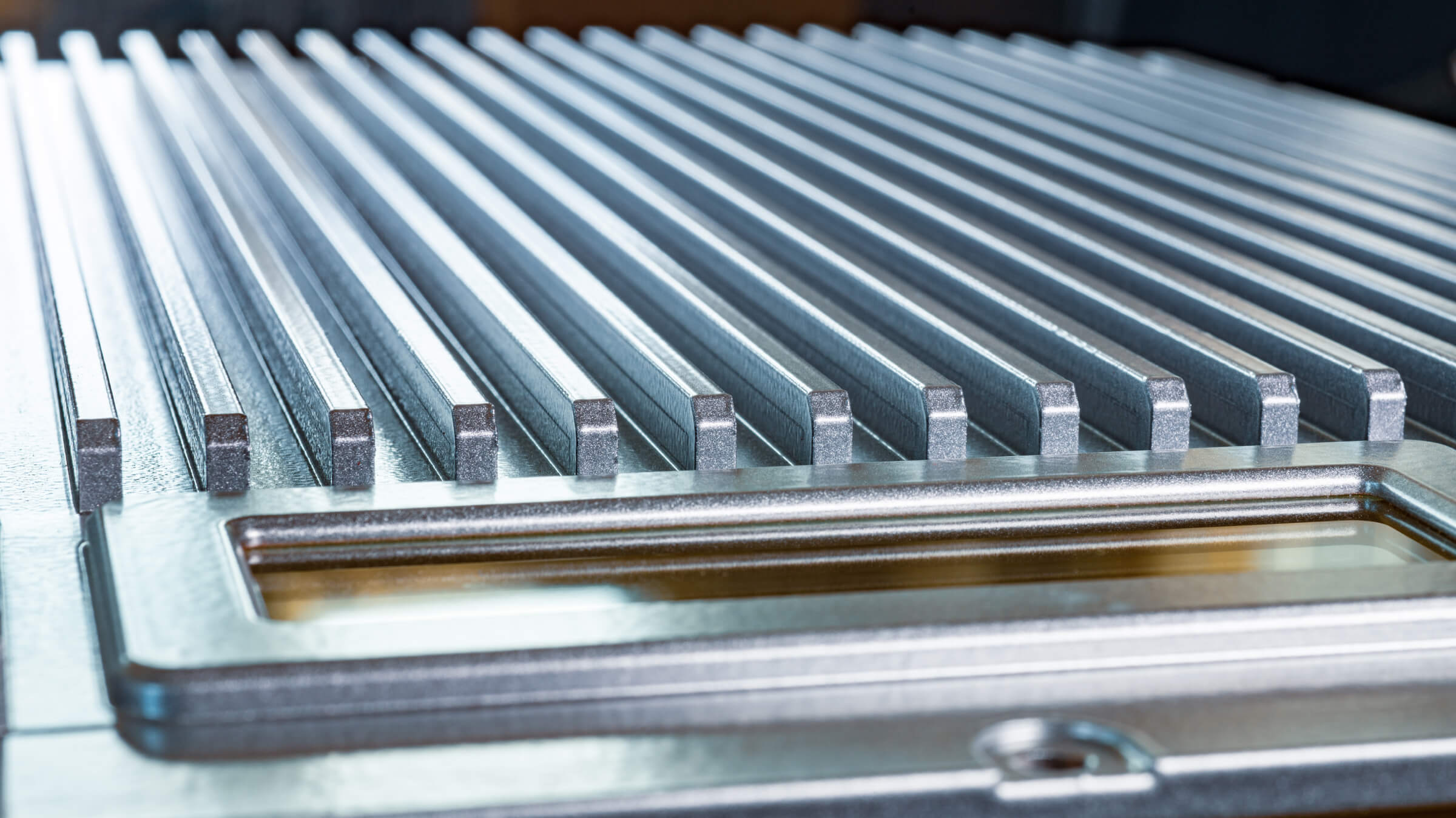 Close-up of high-performance aluminum die-cast cooling fins for a power inverter, engineered with ADC-12 alloy for optimal thermal conductivity.